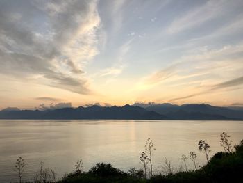 Scenic view of lake against sky during sunset