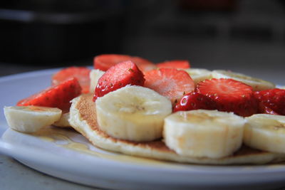 Close-up of fruits in plate on table