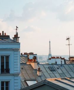 Buildings against cloudy sky
