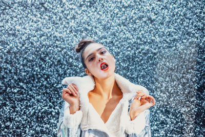 Portrait of woman carrying crystal in mouth