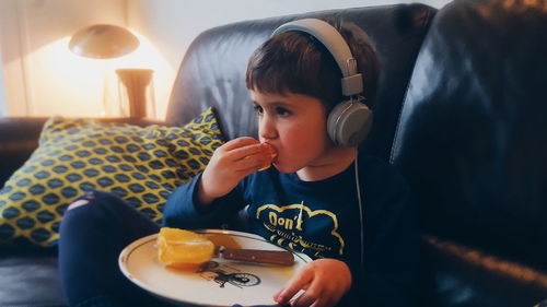 Portrait of boy sitting at home