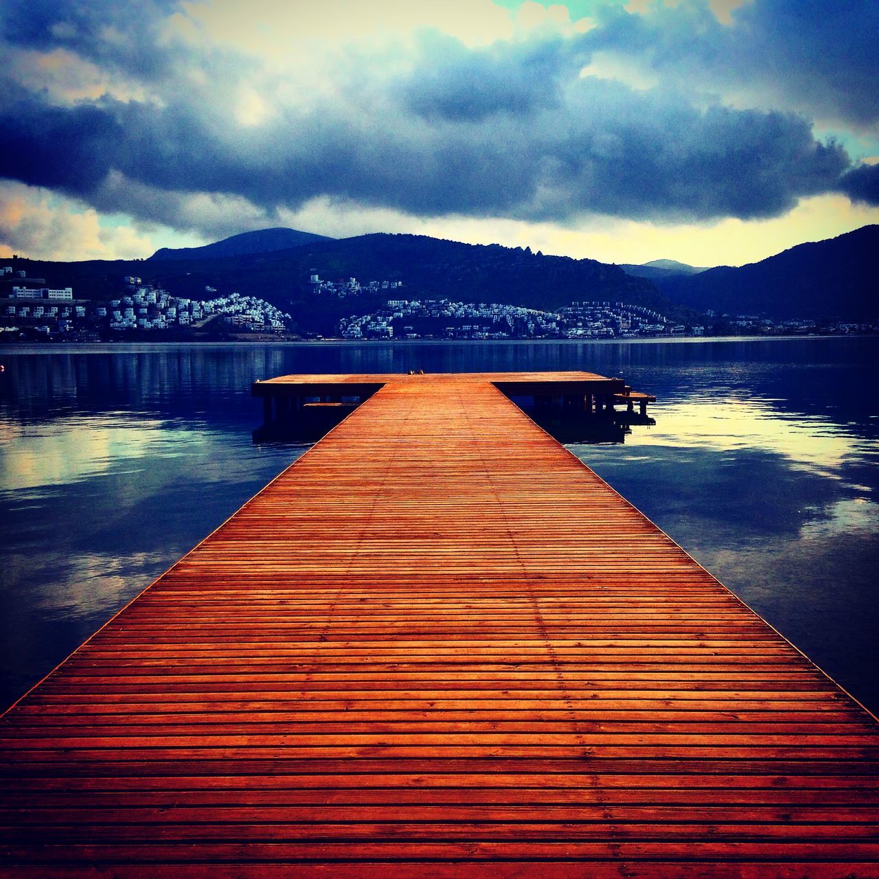 water, sky, pier, cloud - sky, mountain, tranquil scene, built structure, sea, jetty, tranquility, scenics, cloud, beauty in nature, lake, wood - material, cloudy, nature, dusk, the way forward, boardwalk