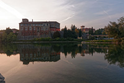 Ancient fortress reflected on the river at sunset