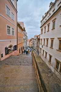 People walking on street amidst buildings in city