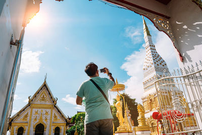 Low angle view of people looking at temple