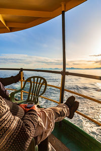 People drinking a glass of wine at sunset on a cruise ship