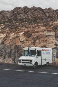 Car on road by rocky mountains