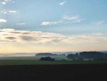 Scenic view of field against sky during sunset