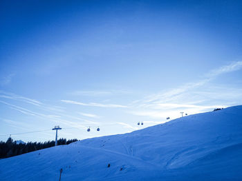 Scenic view of snowcapped mountains against blue sky