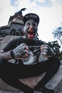 Low angle view of man against sky during halloween