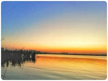 Scenic view of sea against clear sky during sunset