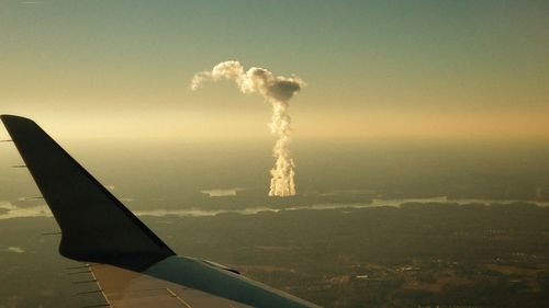 Airplane on landscape against clear sky