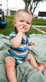 Cute boy sitting on sofa