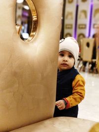 Boy standing against wall
