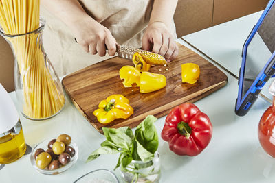 High angle view of woman preparing food on cutting board