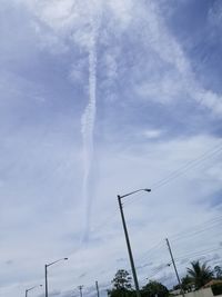 Low angle view of vapor trails against sky