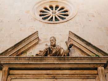 Low angle view of statue against temple