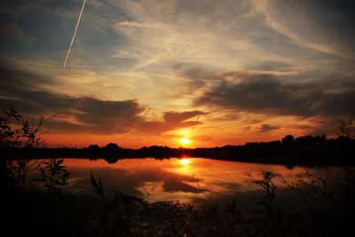 Scenic view of orange sky reflection in lake during sunset