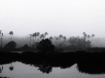 Scenic view of lake against sky during foggy weather