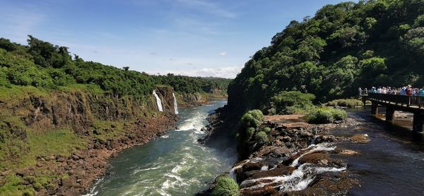 Scenic view of waterfall against sky