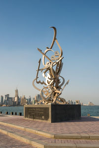 Sculpture of buildings against clear blue sky