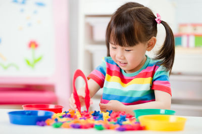 Girl playing with multi colored table