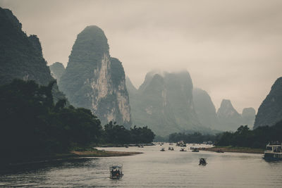 Scenic view of river and mountains against sky