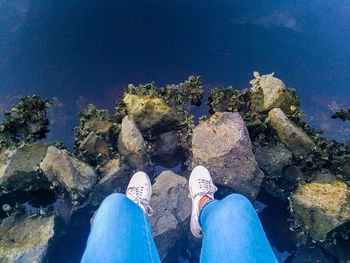 Low section of man with reflection in water