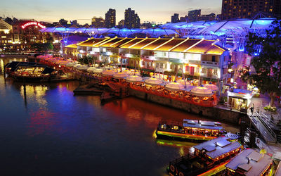 High angle view of illuminated boats in canal at night