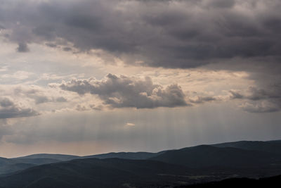 Scenic view of mountains against dramatic sky