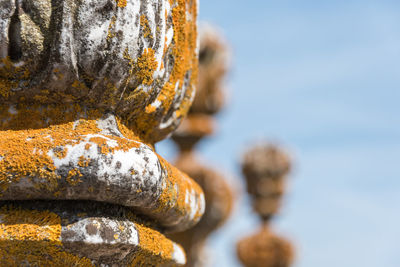 Close-up of rusty metal against sky