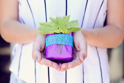 Close-up of woman holding colorful present