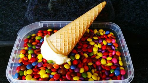 High angle view of multi colored candies in container