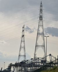 Low angle view of electricity pylon against sky