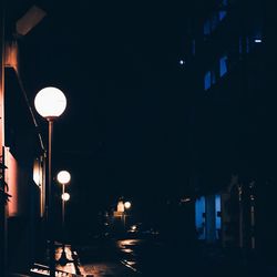 Low angle view of illuminated building against sky at night