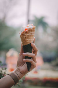 Cropped hand of woman holding ice cream cone