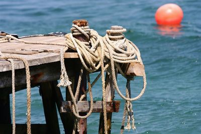 Rope tied on wooden posts in sea