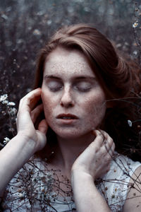 Close-up of young woman with eyes closed