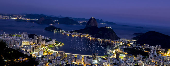 High angle view of city lit up at night