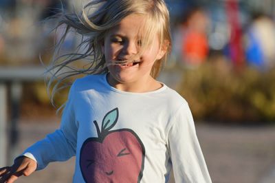 Portrait of cute girl standing outdoors