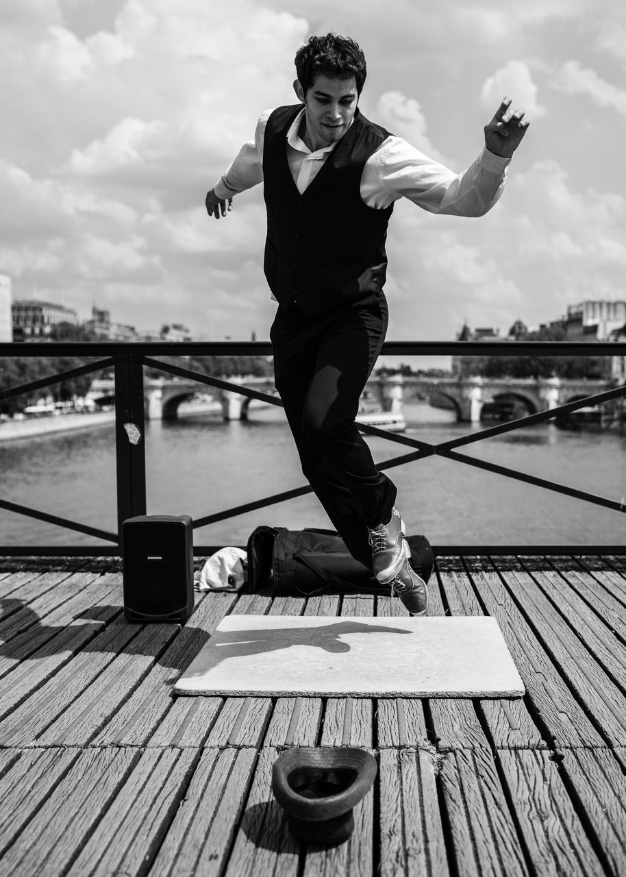 FULL LENGTH OF MAN STANDING ON PIER