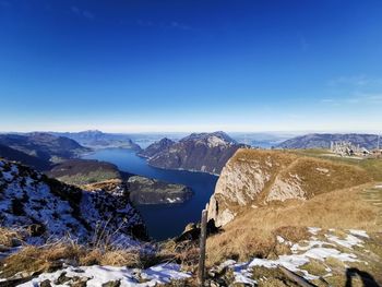 Scenic view of snowcapped mountains against blue sky