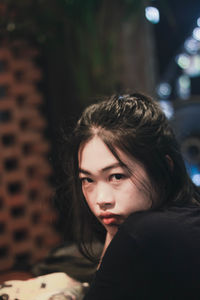 Close-up portrait of young woman looking away