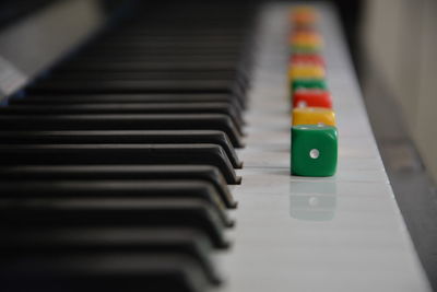 Close-up of multi colored dices on piano