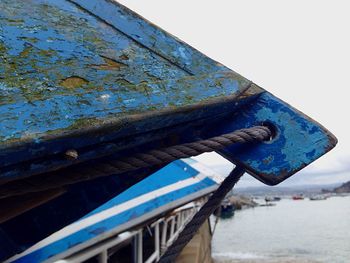 Low angle view of boat moored on sea against clear sky