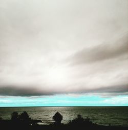 Scenic view of sea against cloudy sky