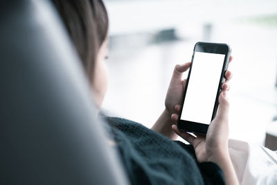 Midsection of man using mobile phone