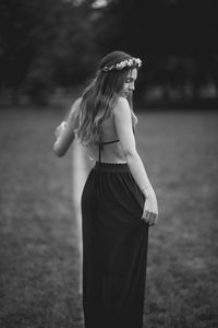 Midsection of woman standing on field