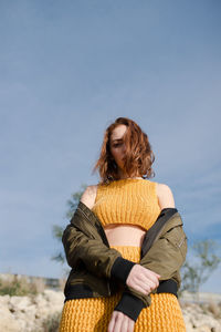 Rear view of woman standing against sky