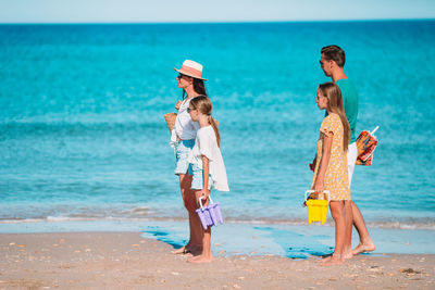 People on beach by sea